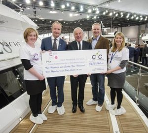 Cheque to €285,500 presented to Cancer Research UK by Cogs4Cancer aboard Sunseeker 28 Metre Yacht at London Boat Show 2015