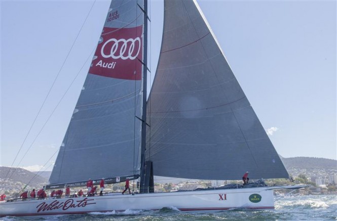 WILD OATS XI (AUS) crossing the finish line to claim her eighth Line Honours victory in the 2014 Rolex Sydney Hobart Race - Photo by Rolex Daniel Forster