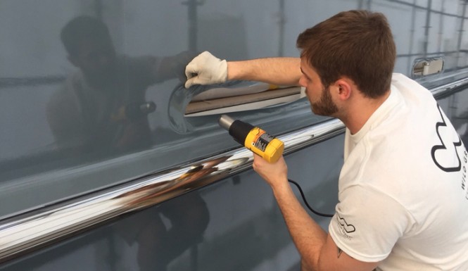 Wild Group staff working on full hull wrap of Aviva yacht