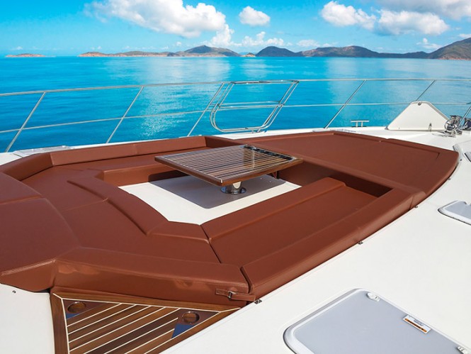 Luxury yacht Life Serenity – the first Riviera 77 Enclosed Flybridge – features a luxurious coffee table setting and sun pad on the forward deck
