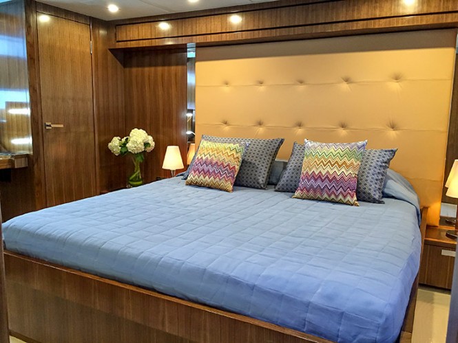 The 77 Enclosed Flybridge yacht Life Serenity has a full-beam master stateroom with contemporary headboard for its king-sized bed amidships has all the comforts of a world-class luxury resort
