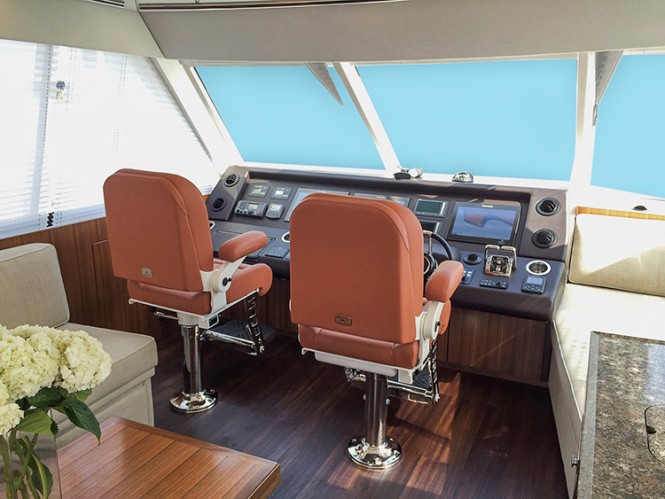 The flybridge of Riviera's 77 Enclosed Flybridge yacht Life Serenity provides excellent, 360-degree visibility from either of the electrically adjustable helm chairs