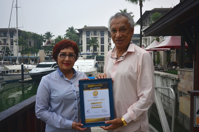 Mrs Woranart Wongvanich, Marina Manager & Mr Gulu Lalvani,  Chairman;  Royal Phuket Marina, displaying 5 Gold Anchor certificate