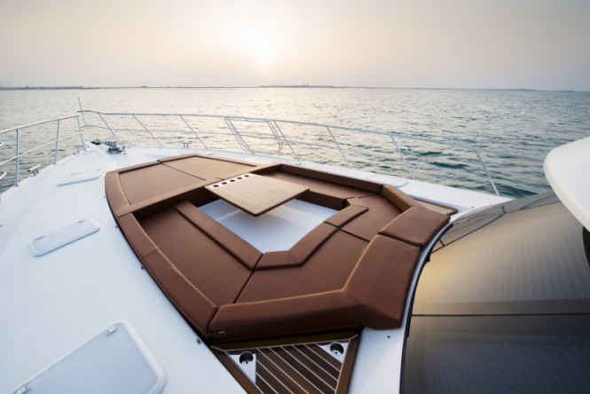 Riviera 77 Enclosed Bridge Yacht - sun pad and casual diningsitting area on the foredeck