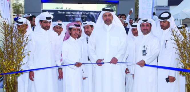 HE the Minister of Economy and Commerce Sheikh Ahmed bin Jassim bin Mohamed al-Thani cutting a red ribbon to formally open QIBS 2015