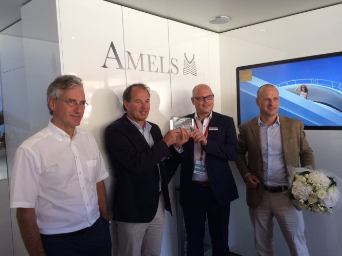 During the jubilee ceremony, Raytheon Anschütz’ Arno Nommensen hands over a certificate about the 100th Superyacht INS to AMELS’ Victor Caminada and Martin van Heulen