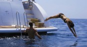 A superyacht charter diving in from the aft deck