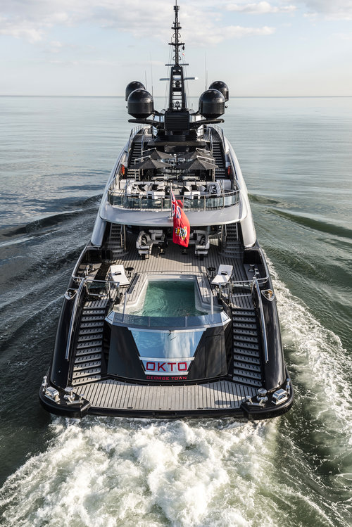 Superyacht OKTO - View of the stern beach club, swimming pool and upper deck aft alfresco salon