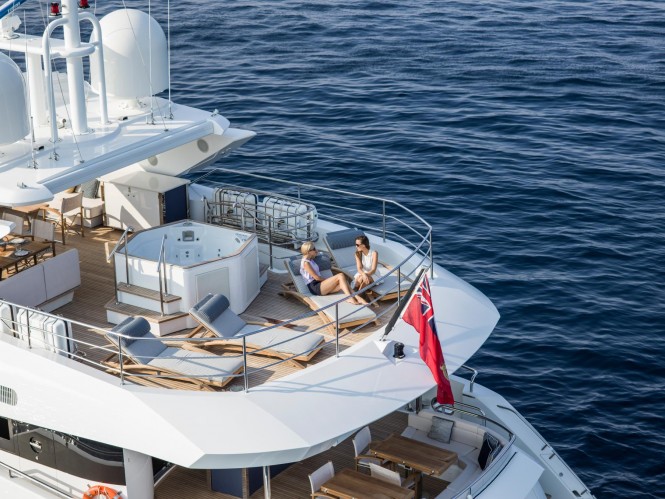 The aft sundeck Jacuzzi and sun loungers aboard superyacht FLEUR