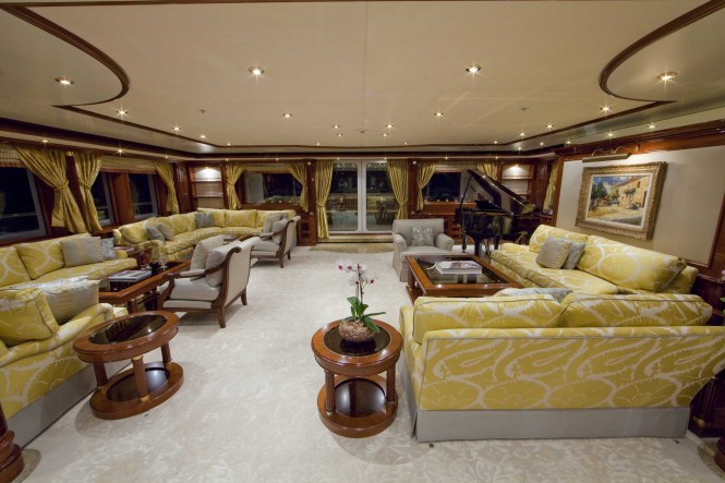 The main salon with grand piano, bar and games table aboard superyacht TITANIA