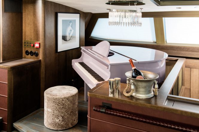 The upper salon baby grand piano aboard sailing yacht PINK GIN VI