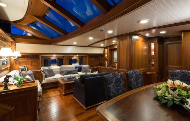 Beautiful saloon with comfortable seating area and elegant dining table