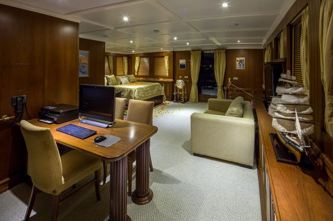 Master stateroom with a seating area and an office/study