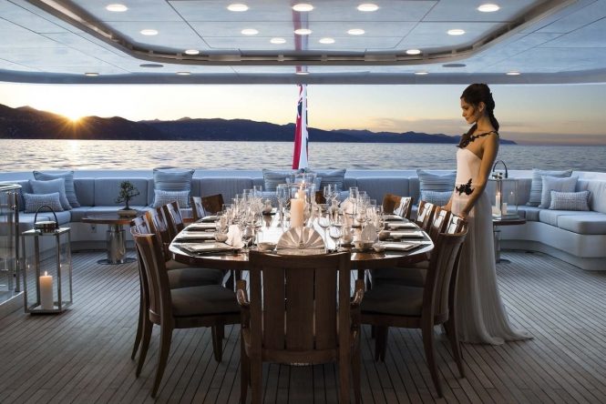 Stunning sunset dinners on the aft deck around the formally set dining table for all charter guests