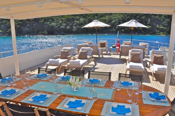 Superyacht LIONSHARE - Alfresco dining and outdoor saloon on the upper deck aft