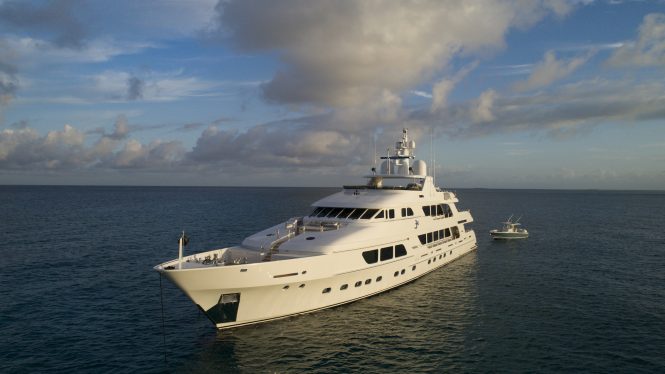 THREE FORKS superyacht at anchor with fishing boat