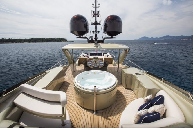 The Jacuzzi, sunpads and alfresco dining area aboard superyacht MIDNIGHT SUN