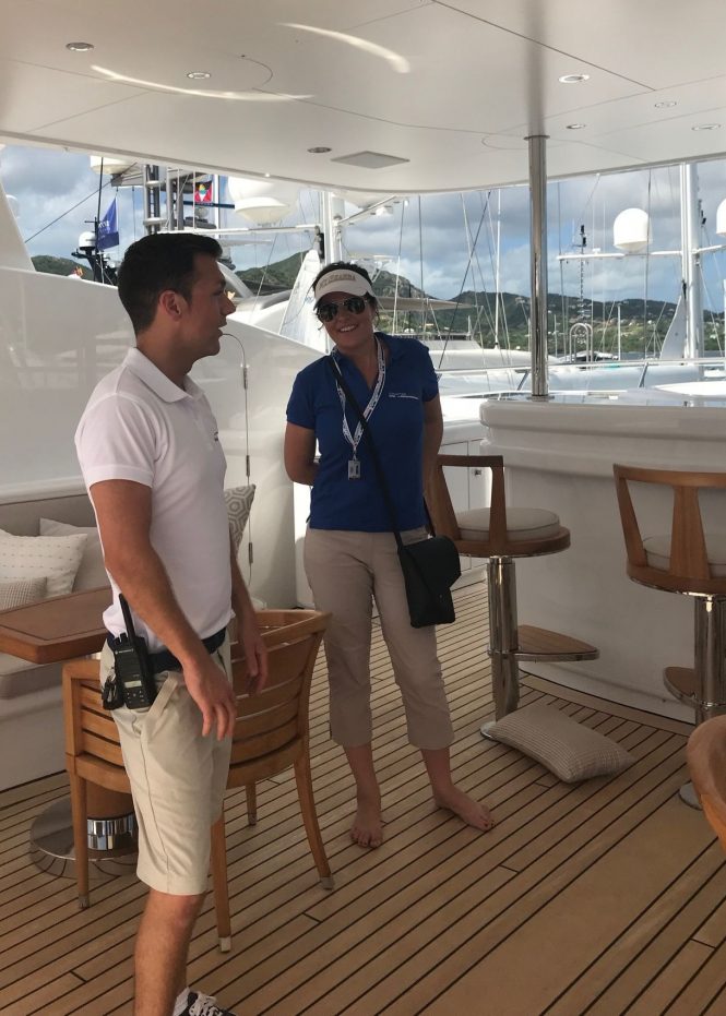 Charter Broker Trina Howes aboard a superyacht with a crew member at the Antigua Yacht Show 2017