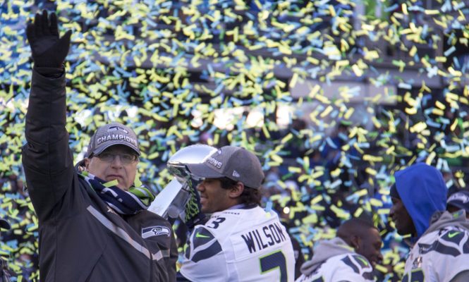 Paul Allen waves to the 12s during the Super Bowl parade and rally at Seattle’s CenturyLink Field in February 2014. Credit Courtesy of Vulcan Inc.