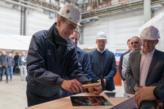 Preparation of the keel laying coin for Project Black Shark superyacht. Holger Kahl hammers a nail on the keel laying plate.- Photo @ Nobiskrug