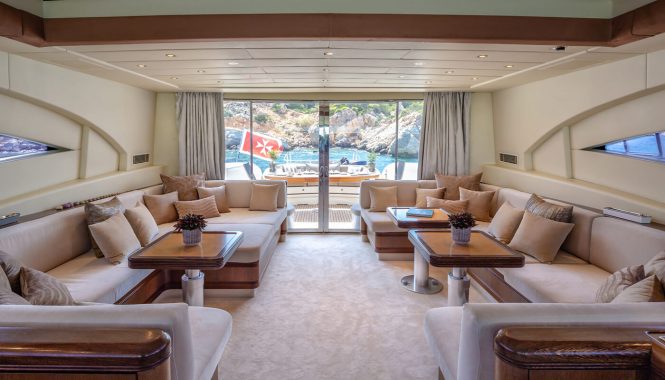 Spacious saloon with large comfy sofas that opens up onto the aft deck