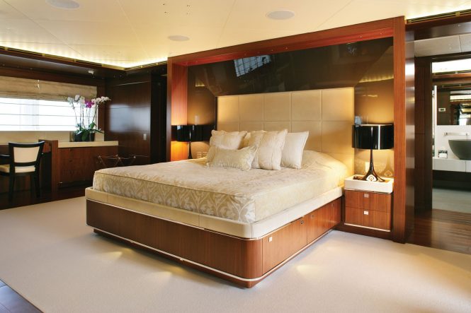 Master stateroom with a large bed and private ensuite luxury bathroom