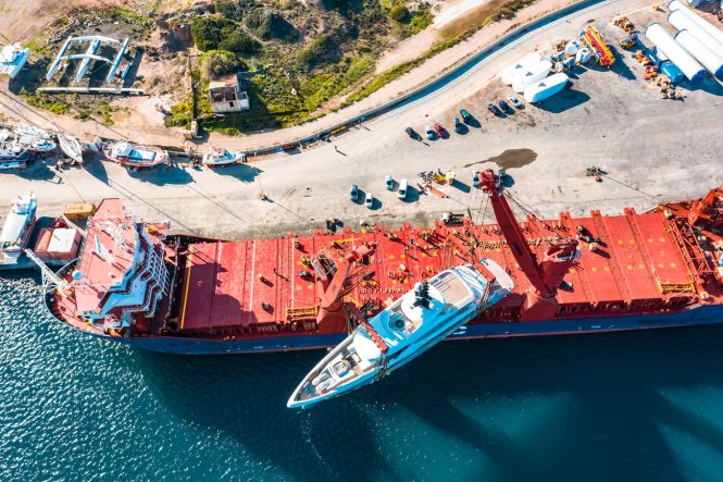 SNOW 5 yacht being loaded onto cargo ship