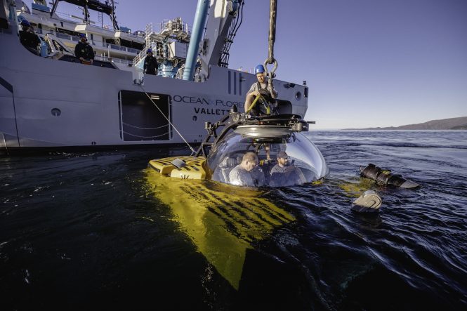 Triton submersible is lowered into the water as the ships crew and science team test its systems in preparation for future missions - Credit Taj Howe