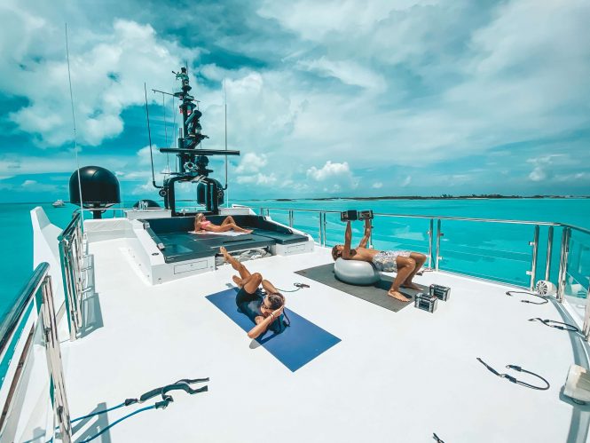 gym equipment on deck and sunbathing area