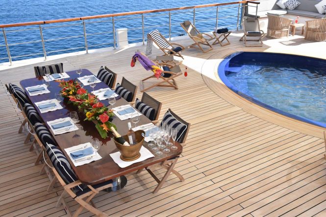 Aft deck with alfresco dining area and a freshwater pool