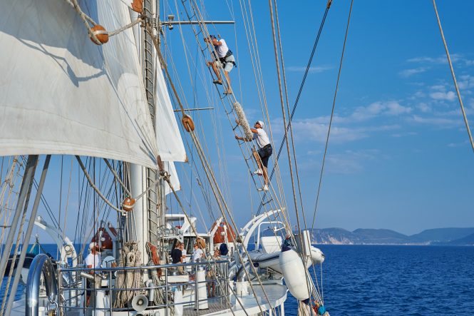 Climbing the rigging on board