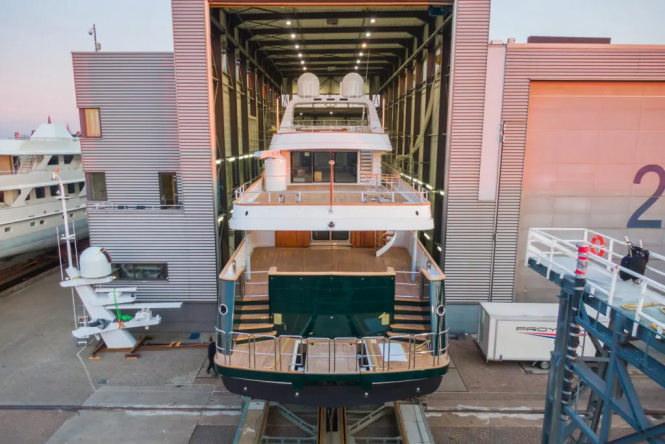 Classic motor yacht EMERALD stern emerges from the shed