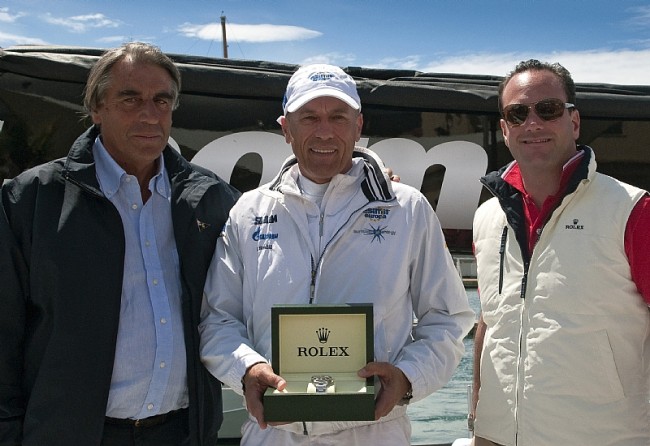 Igor Simcic, owner of ESIMIT EUROPA 2, receives a Rolex timepice from Lionel Schurch, Rolex SA