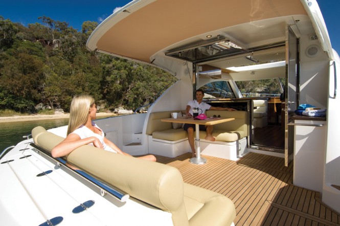 A large glass door and window opens to connect the saloon to the cockpit on the Riviera 5000 Sport Yacht A large glass door and window opens to connect the saloon to the cockpit on the Riviera 5000 Sport Yacht
