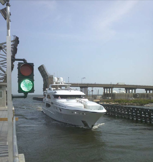 Trinity motor yacht WHEELS passes through the new Seabrook Floodgate Complex sector gates as the first private vessel