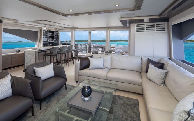 Spacious saloon with a bar area looking aft onto the deck
