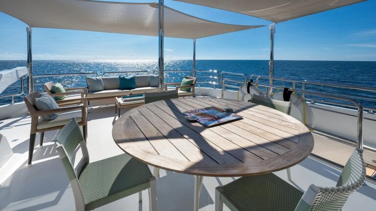 Fly bridge dining under soft bimini