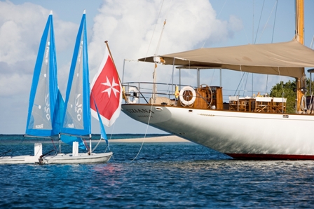 Tiziana at anchor and sailing dinghies
