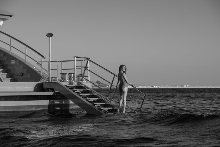 Model Walking Into The Water Off The Yacht