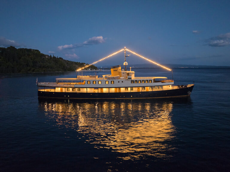 Profile Of The Yacht In The Evening With Lig