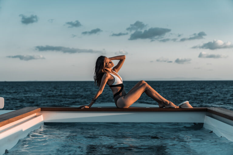 Sunbathing Next To The Pool On A Superyacht