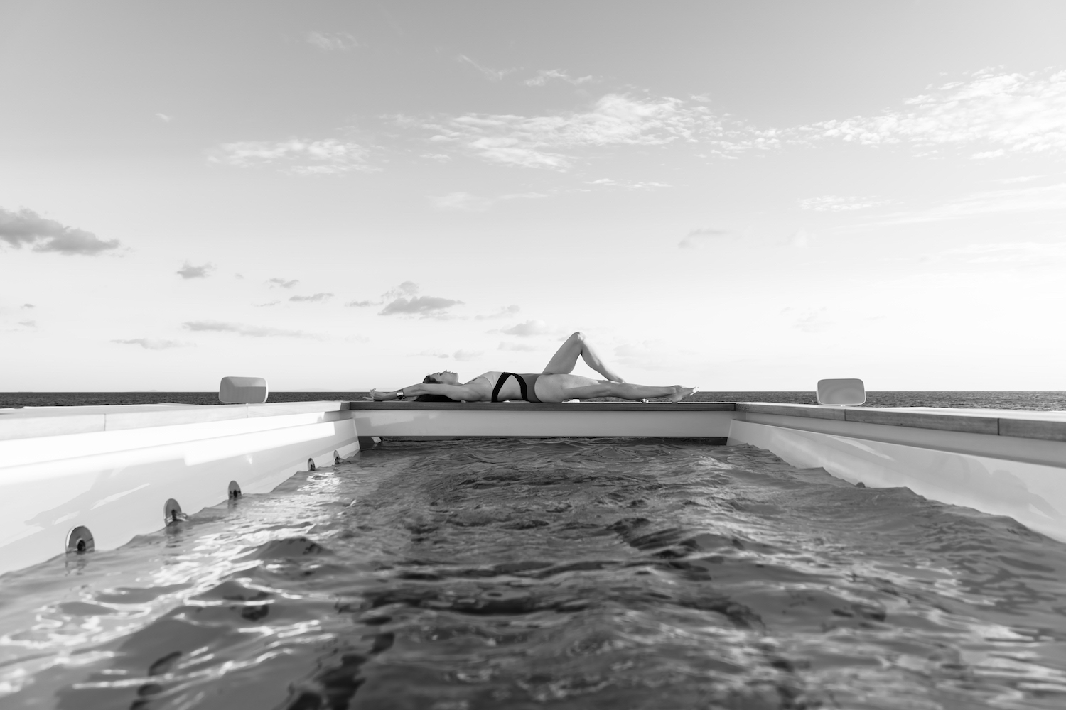 Lady sunbathing at the superyacht pool.jpg