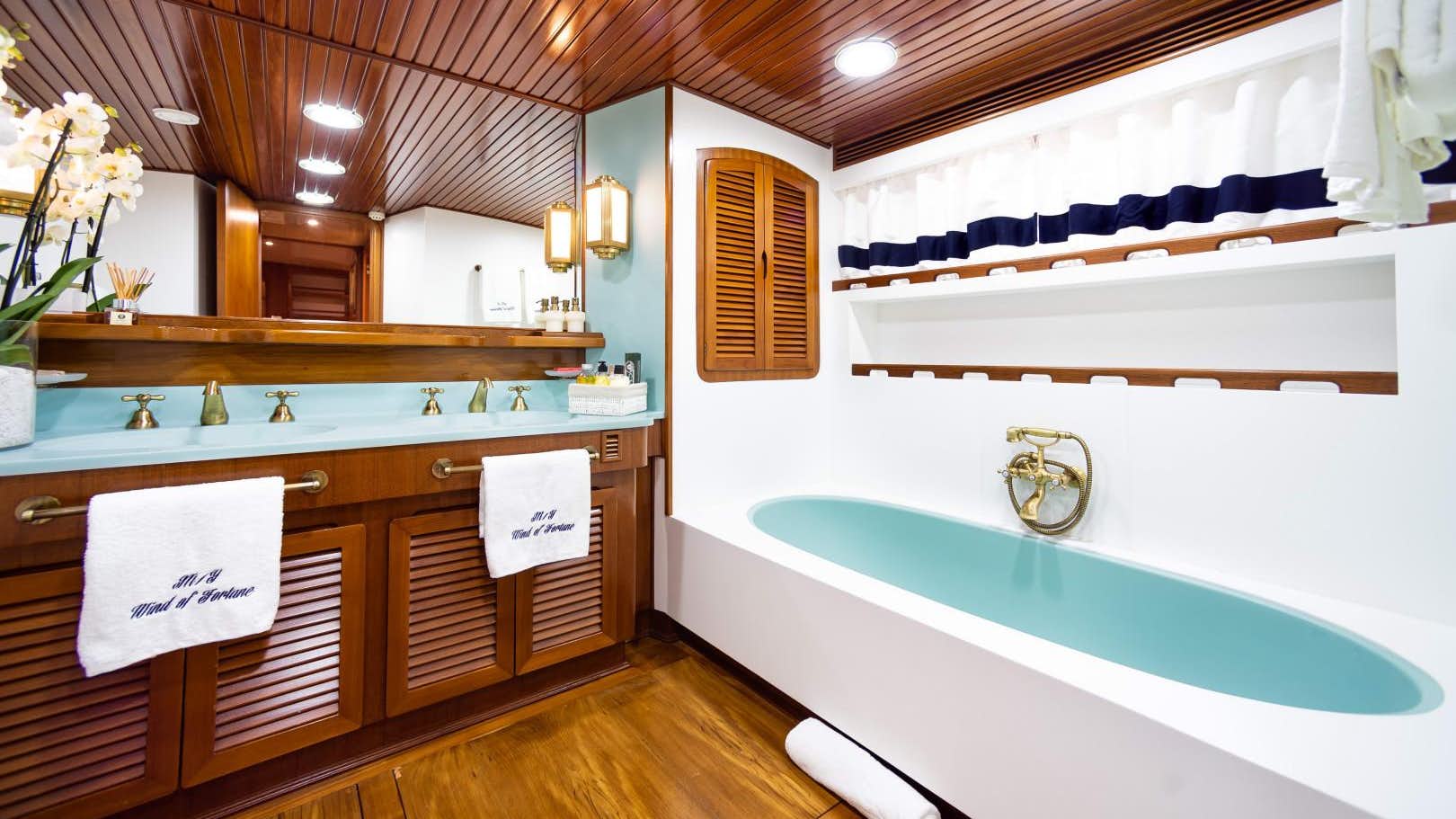a bathroom with a tub sink and cabinets aboa.jpg